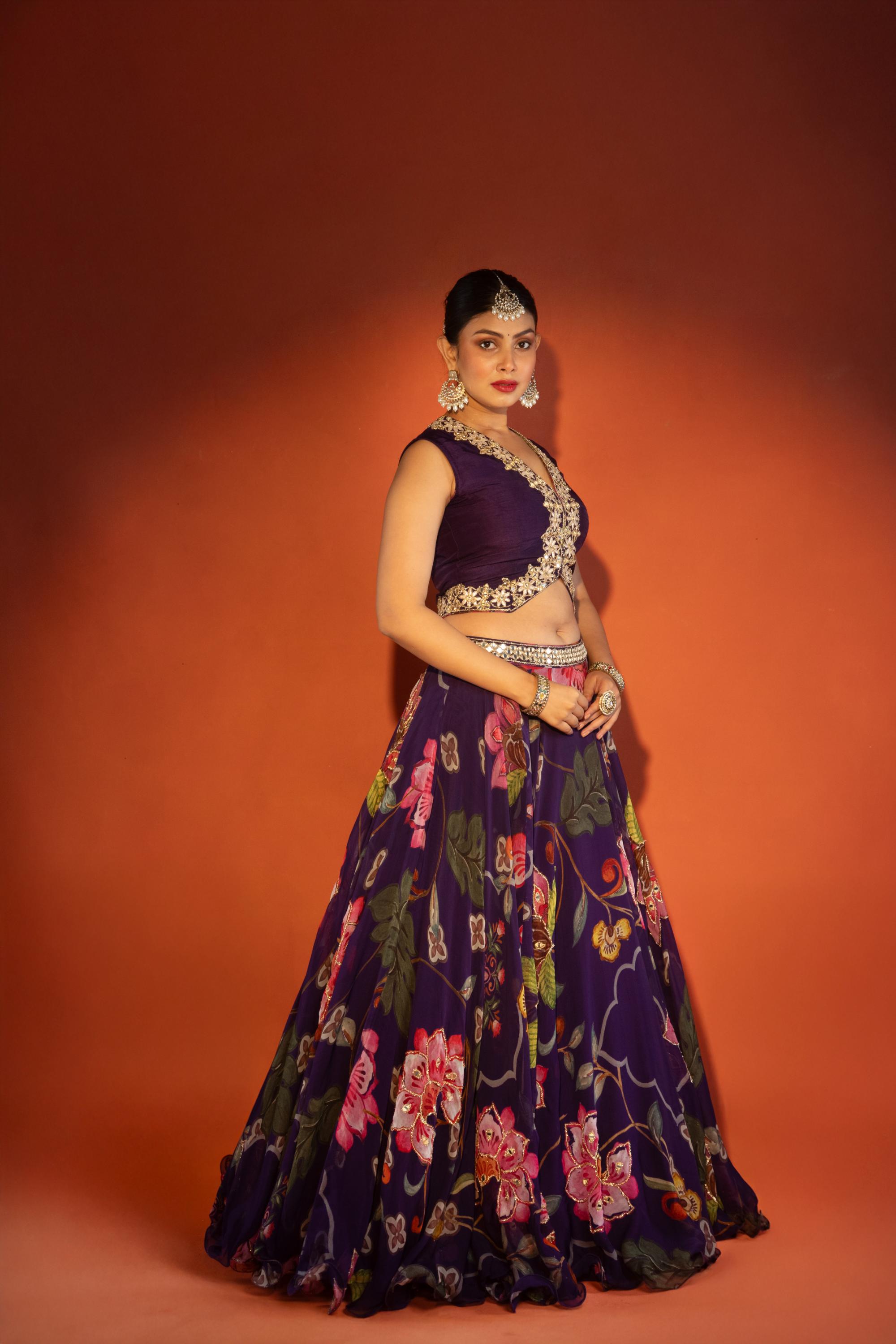 Purple floral lehenga with mirror-work waistcoat and placement dupatta.