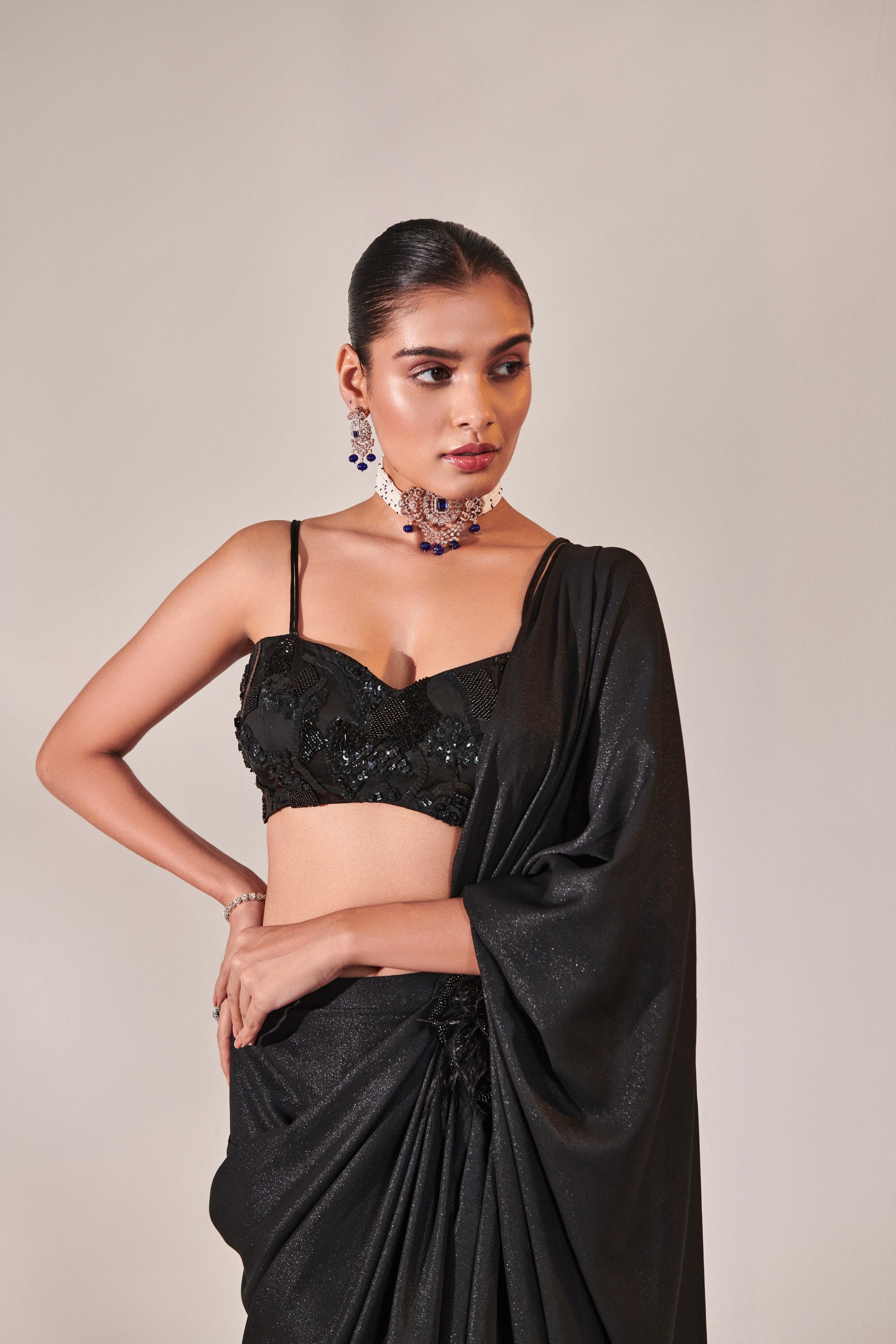 fuss-free pre-stitched drape saree; hand embroidered blouse and feather detailing