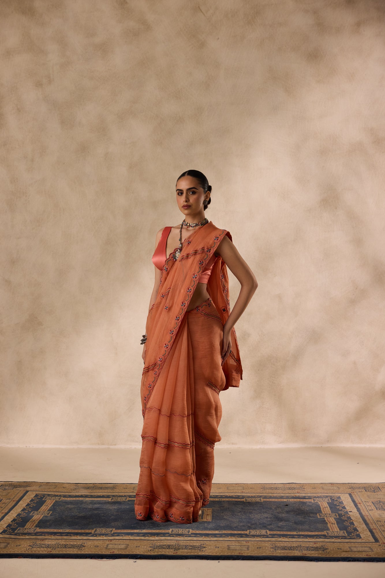 Peach organza scalloped embroidered saree comes with unstitched & unembroidered blouse fabric in chanderi