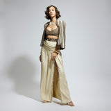 EMBELLISHED & TEXTURED CAPE JACKET PAIRED WITH METALLIC SCALLOP BUSTIER AND IVORY HIGH SLIT SKIRT
