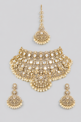 Bold and dramatic polki bridal necklace set with matching earrings and maangtika