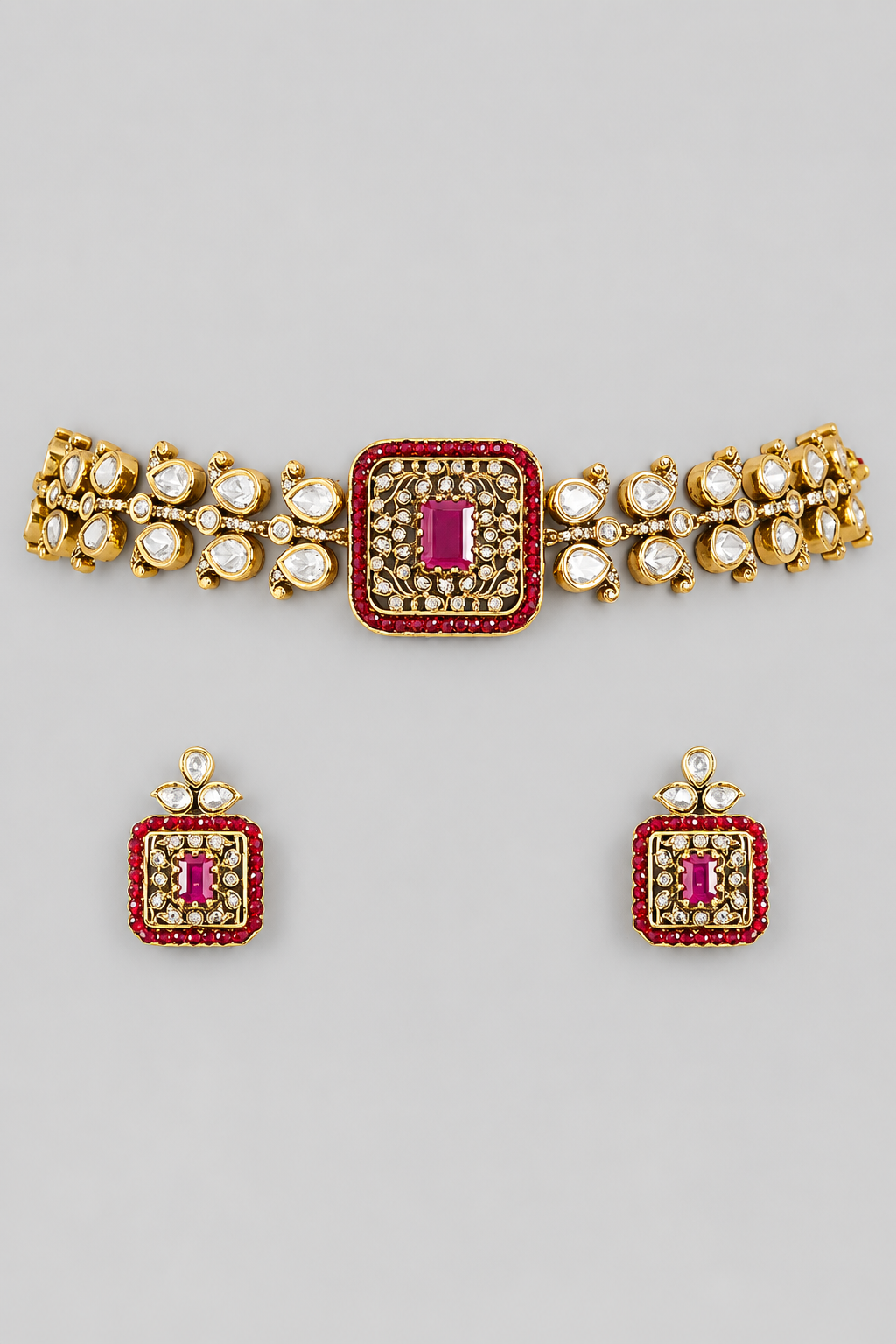 Exclusive and classic two tone finish choker with red stones. It comes with a pair of matching studs