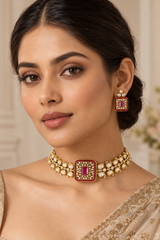 Exclusive and classic two tone finish choker with red stones. It comes with a pair of matching studs