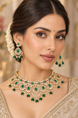 Classic and dramatic kundan necklace set with green stones and pearls. It comes with a pair of matching earrings