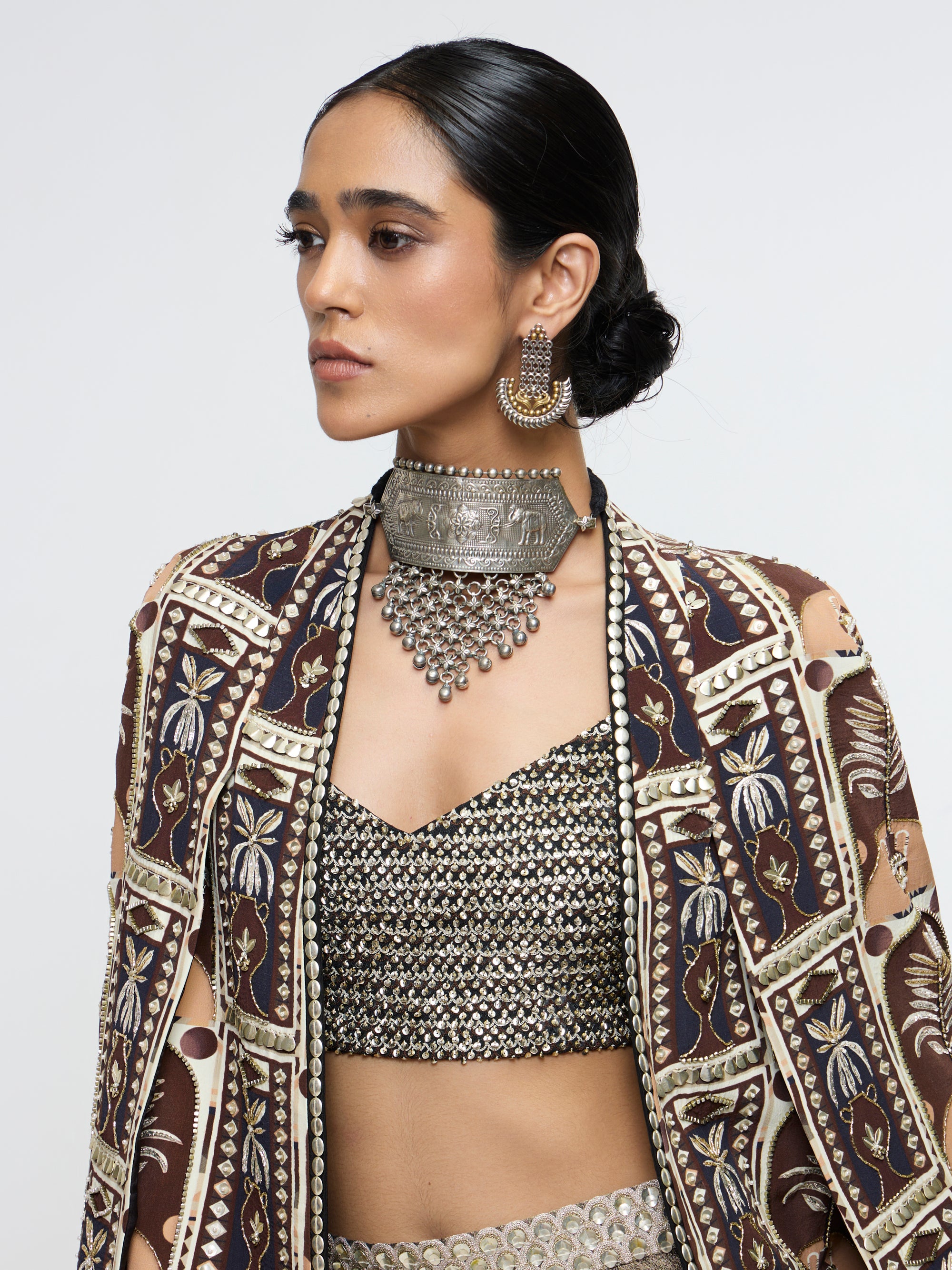 AMER JACKET PAIRED WITH EMBELLISHED BUSTIER AND HIGH-SLIT SKIRT