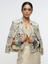 INAYAT EMBELLISHED CAPE JACKET PAIRED WITH METALLIC SCALLOP BUSTIER AND IVORY SLIT SKIRT