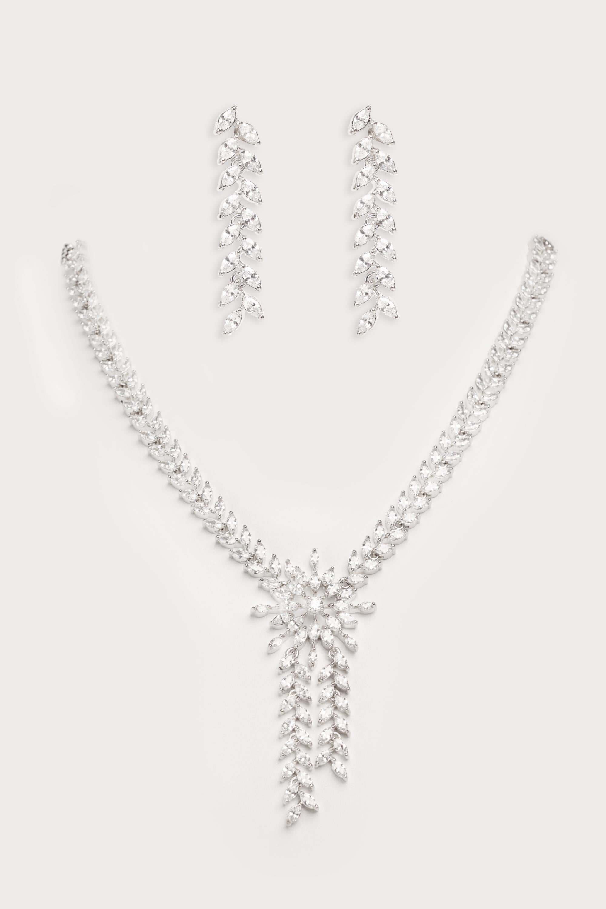 Delicate yet elegant diamond pendant necklace with matching earrings