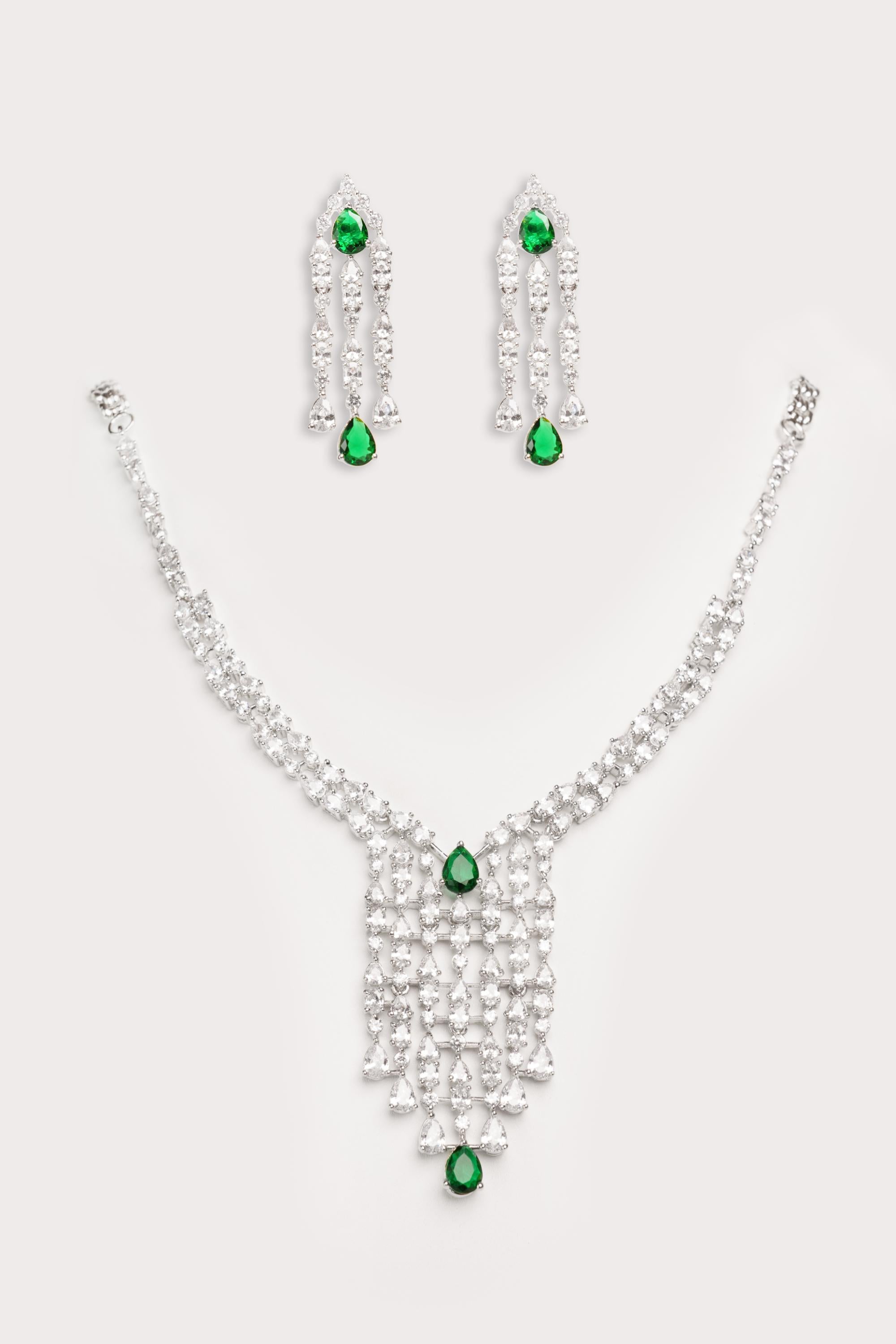 Elegant and sleek diamond pendant set with emerald stone and earrings