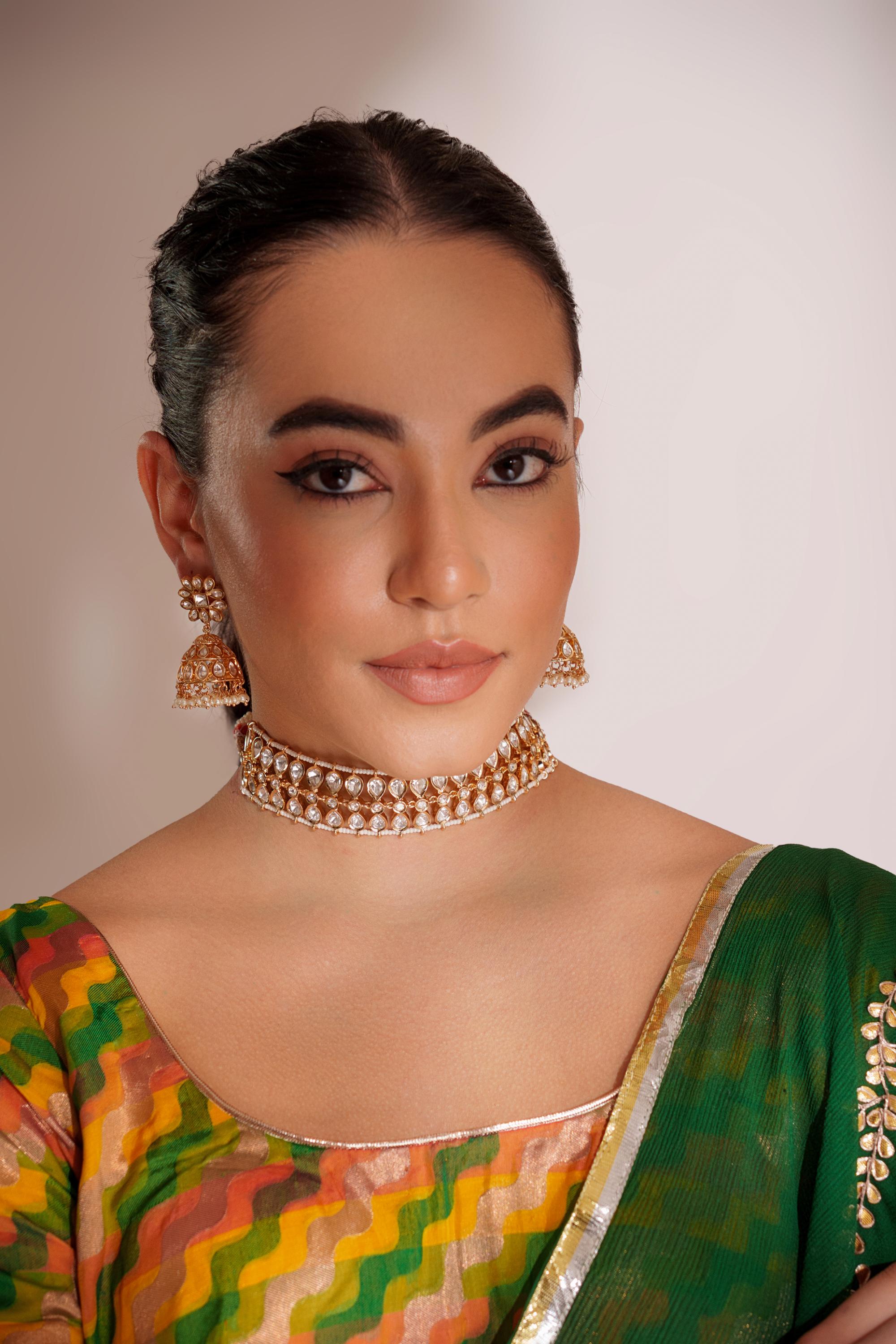Classy kundan choker set with elegant pair of jhumkis.