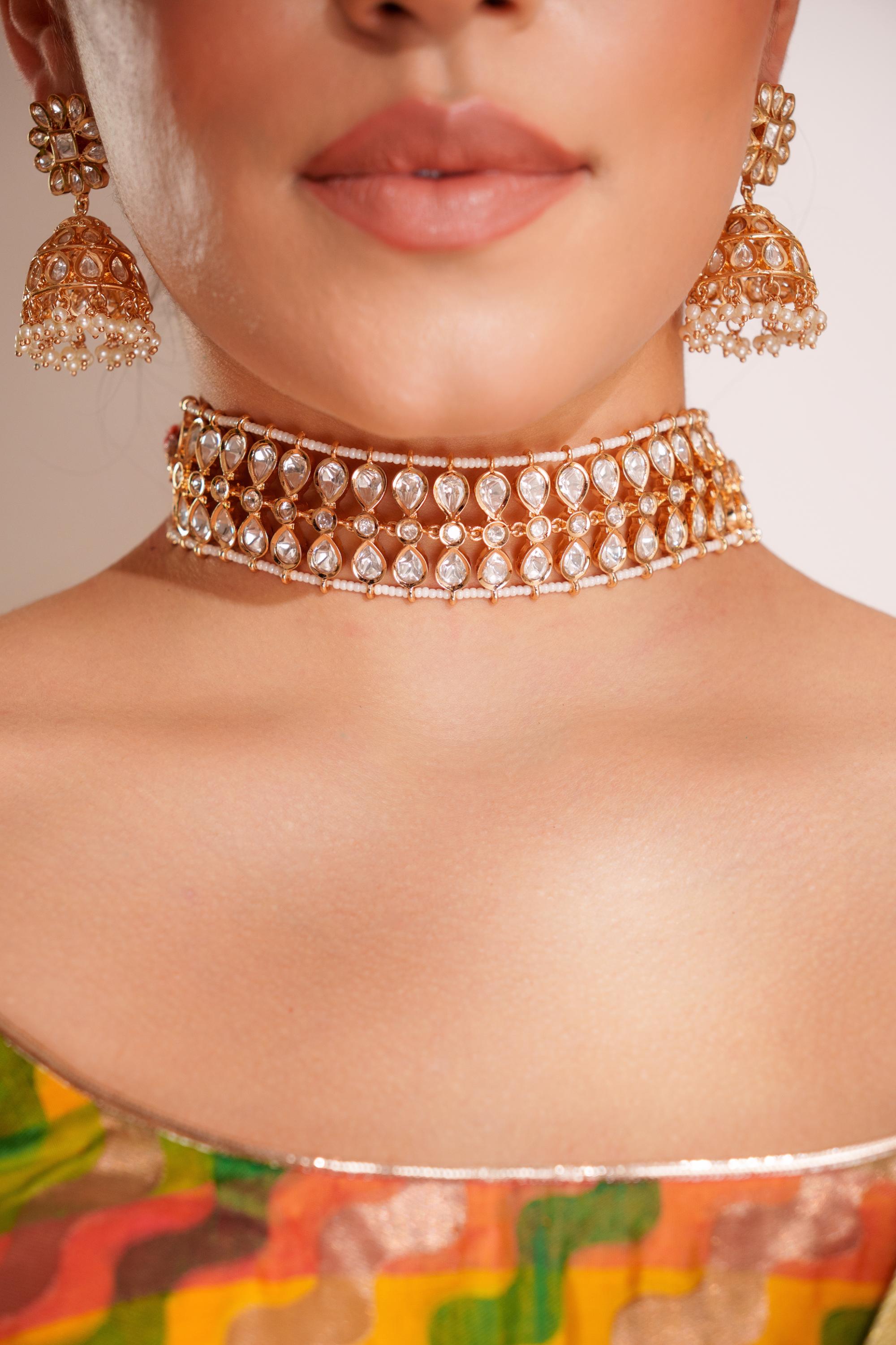 Classy kundan choker set with elegant pair of jhumkis.