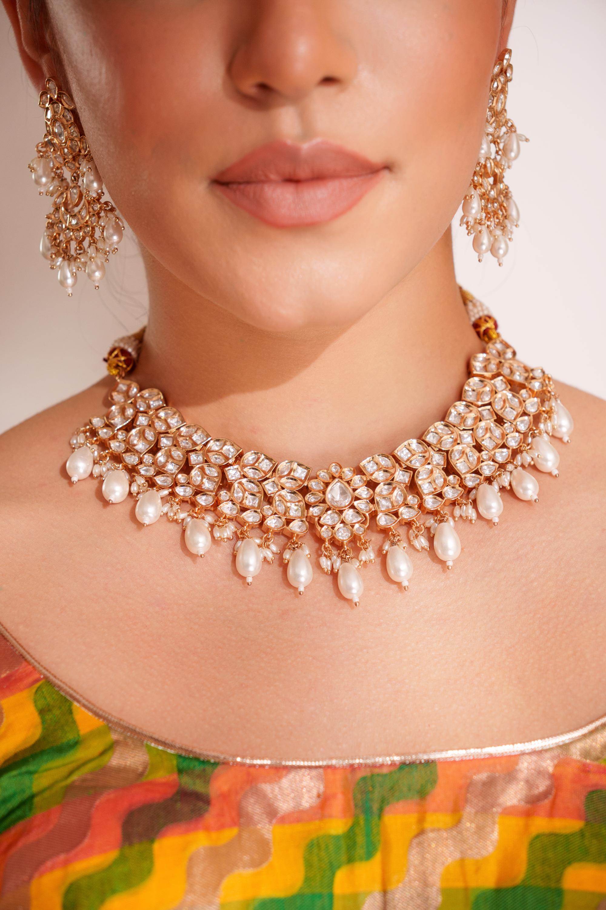Elegant and classy kundan necklace set with earrings and maangtikka studded with pearls