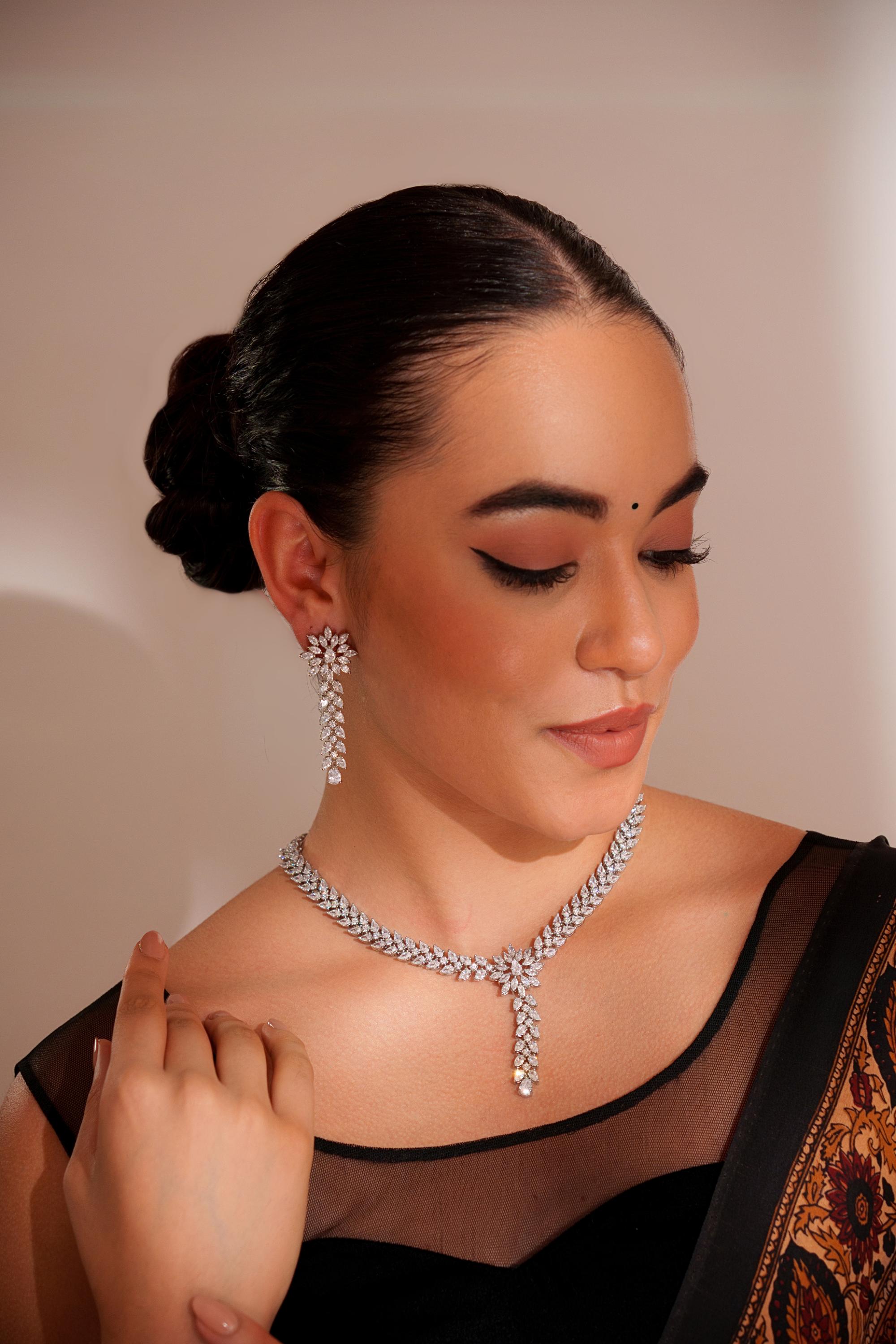 Delicate yet elegant diamond pendant necklace with matching earrings