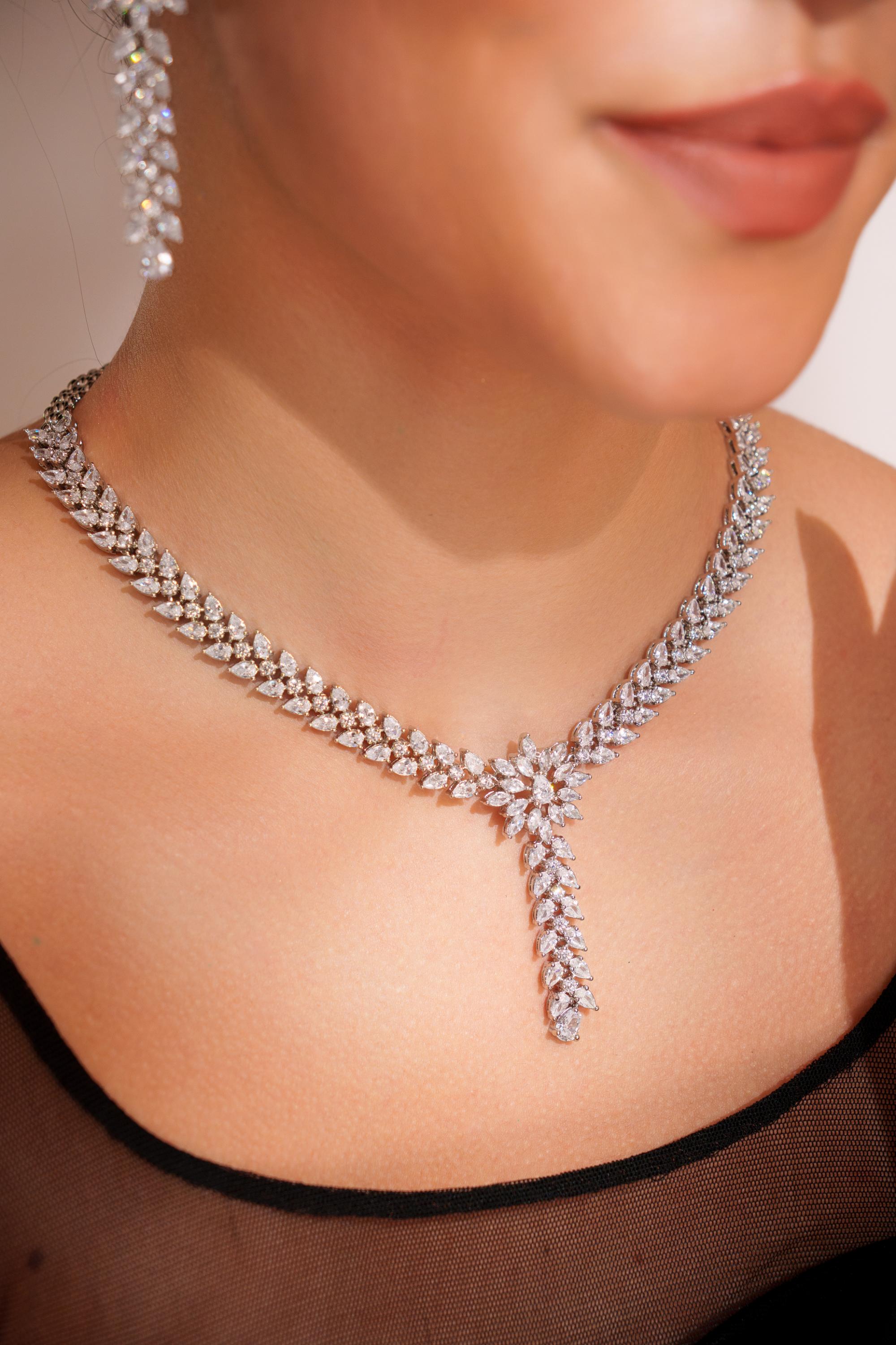 Delicate yet elegant diamond pendant necklace with matching earrings