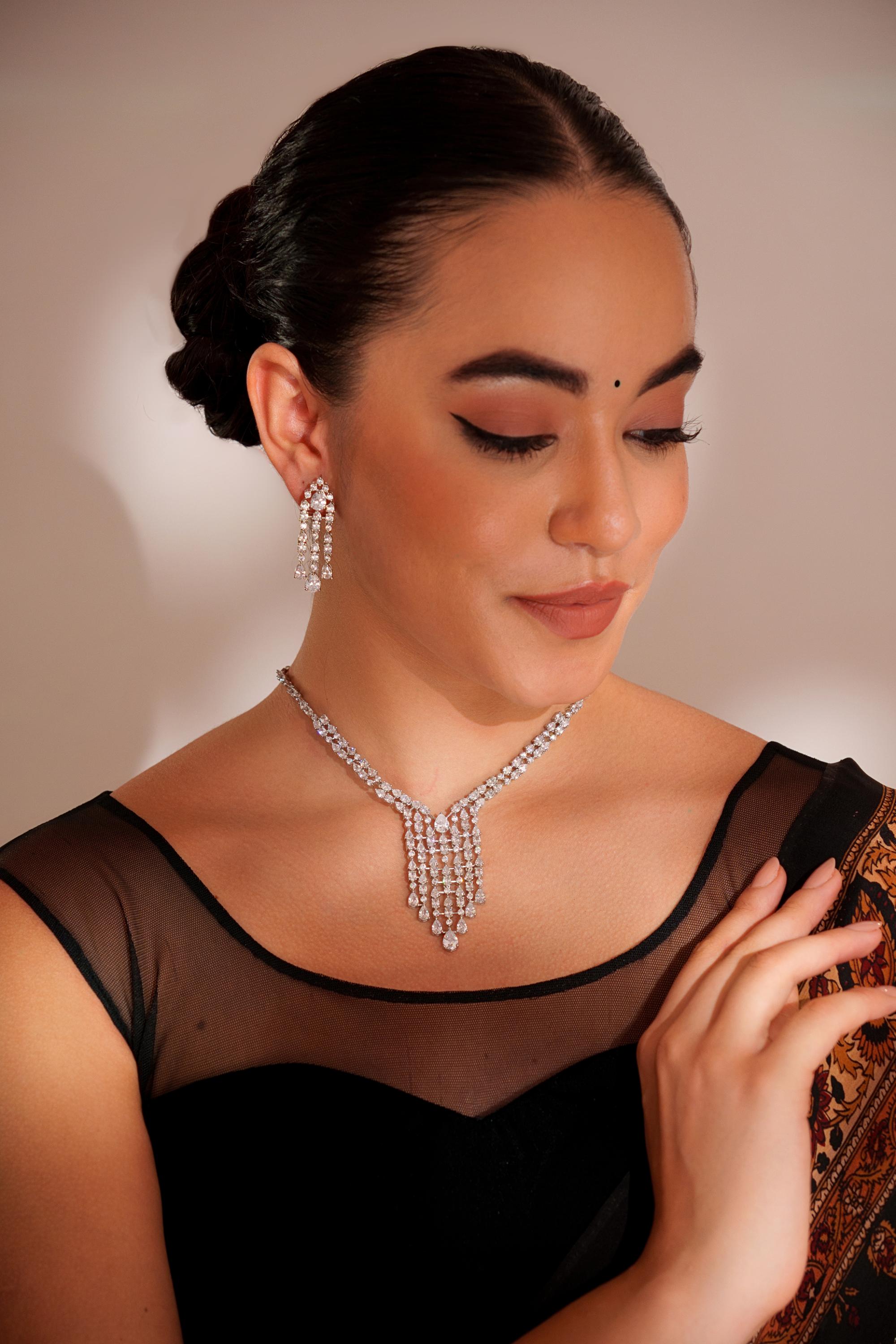 Elegant and sleek diamond pendant set with earrings