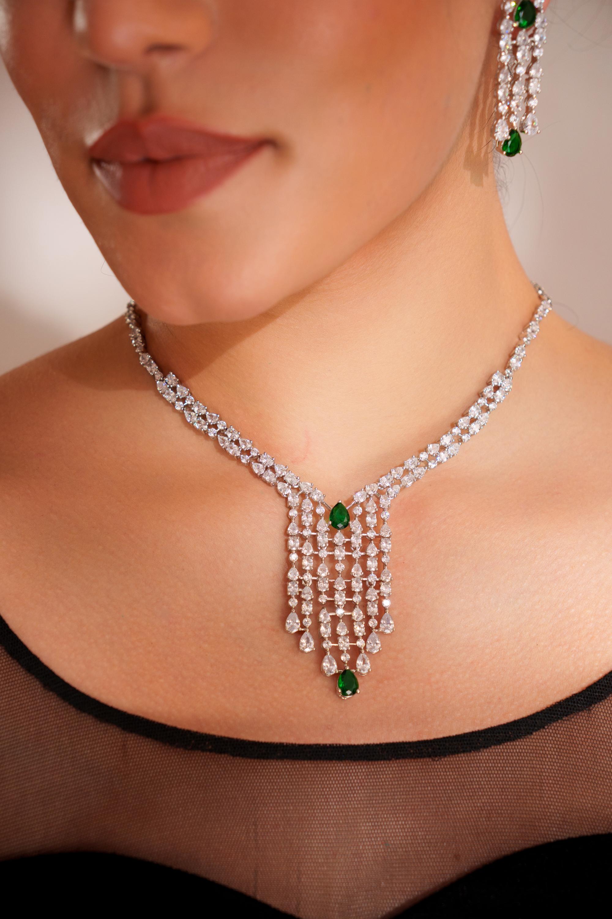Elegant and sleek diamond pendant set with emerald stone and earrings