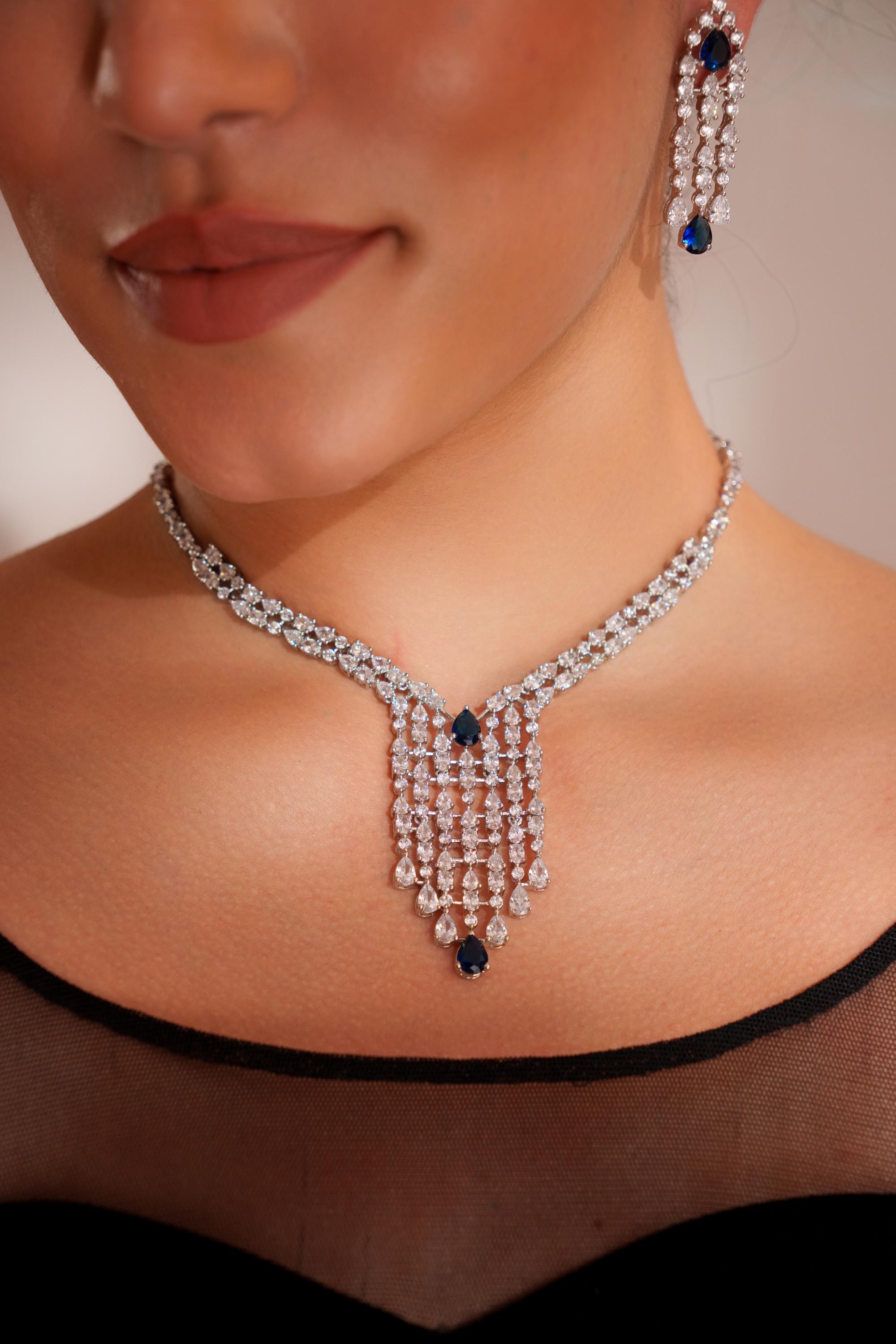 Elegant and sleek diamond pendant set with sapphire stone and earrings