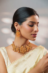 Traditional yet classic kundan temple necklace with elegant pair of earrings