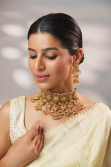 Traditional yet classic kundan temple necklace with elegant pair of earrings