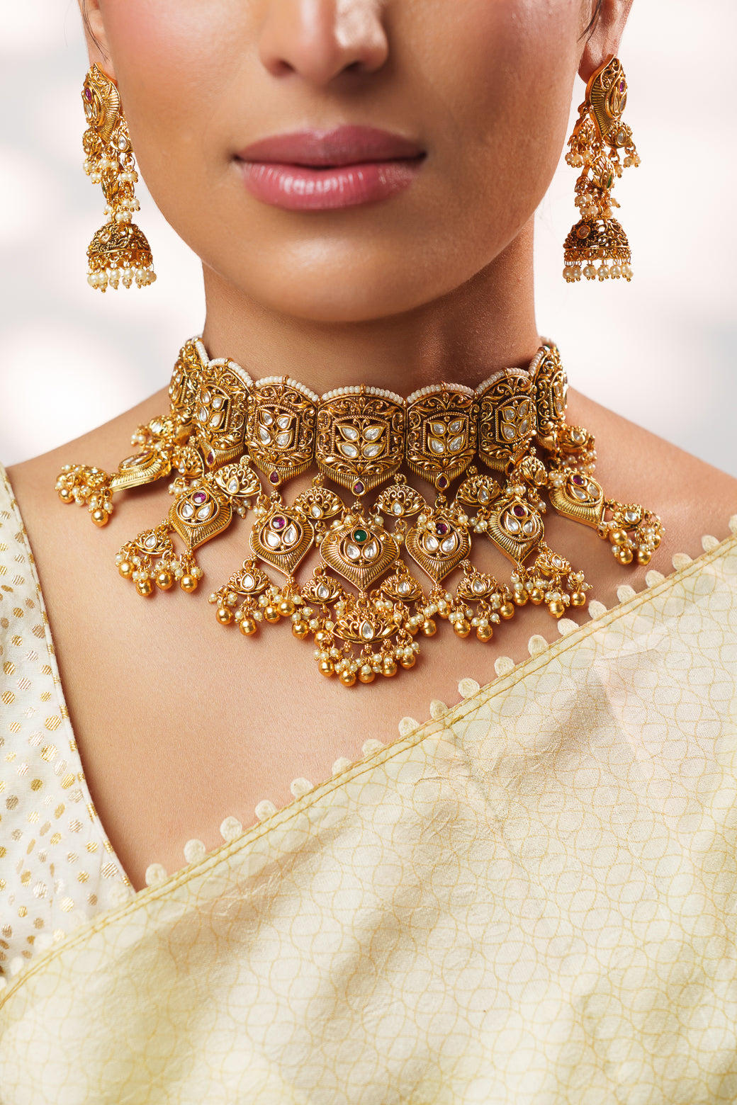 Traditional yet classic kundan temple necklace with elegant pair of earrings