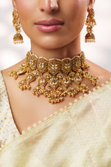 Traditional yet classic kundan temple necklace with elegant pair of earrings