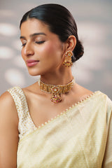 Traditional yet classic kundan temple choker with elegant pair of earrings.