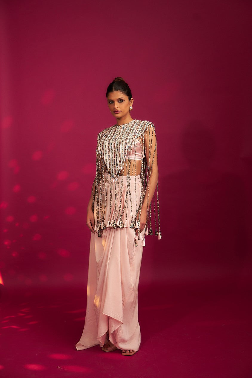 Peachy Pink ajrakh stripwork jacket paired up with Peachy pink bralette and drape dhoti skirt