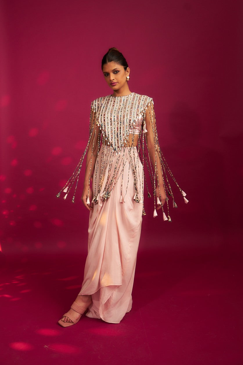 Peachy Pink ajrakh stripwork jacket paired up with Peachy pink bralette and drape dhoti skirt
