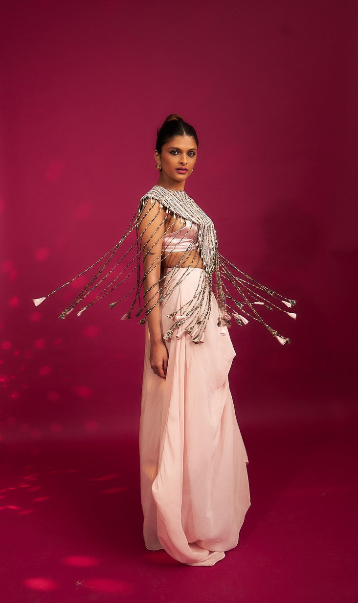 Peachy Pink ajrakh stripwork jacket paired up with Peachy pink bralette and drape dhoti skirt