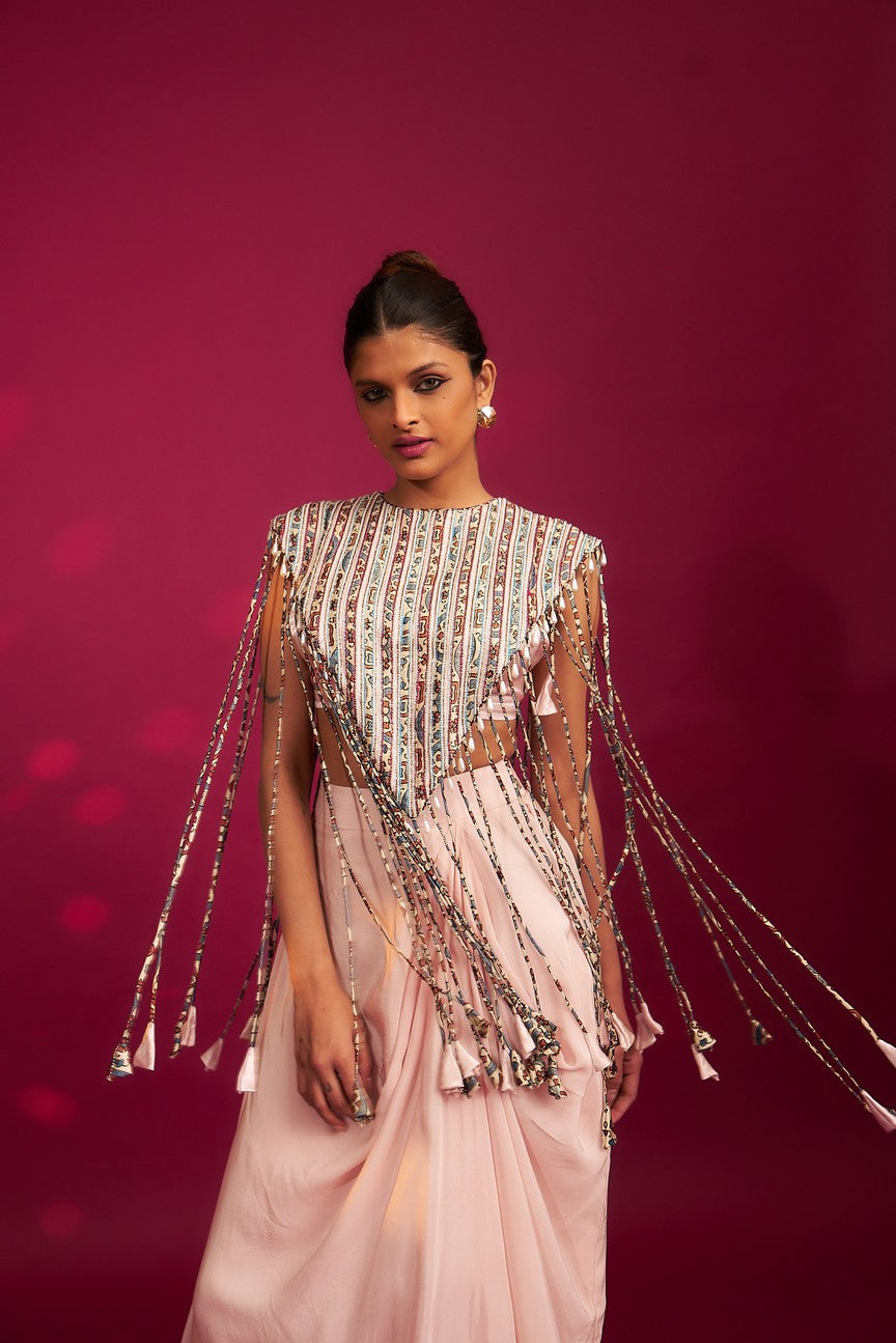 Peachy Pink ajrakh stripwork jacket paired up with Peachy pink bralette and drape dhoti skirt