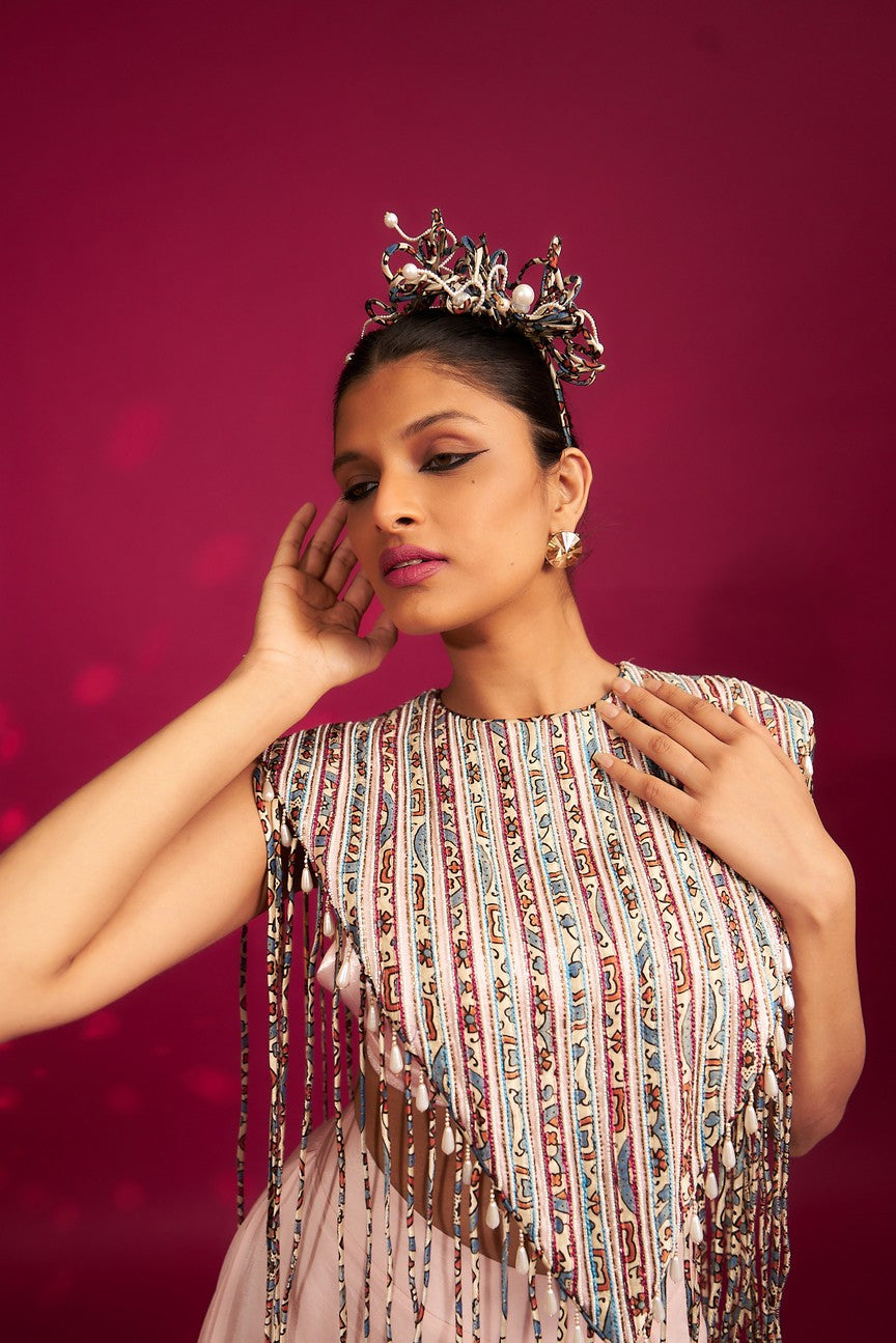 Peachy Pink ajrakh stripwork jacket paired up with Peachy pink bralette and drape dhoti skirt