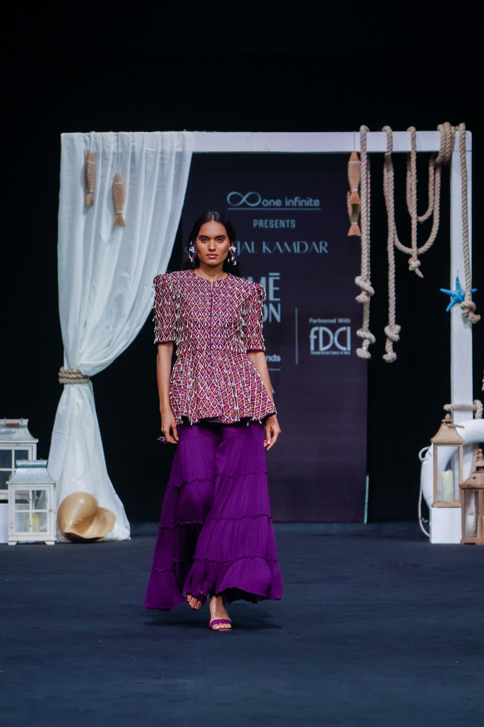 Purple fully embellished ajrakh peplum top with tiered sharara set