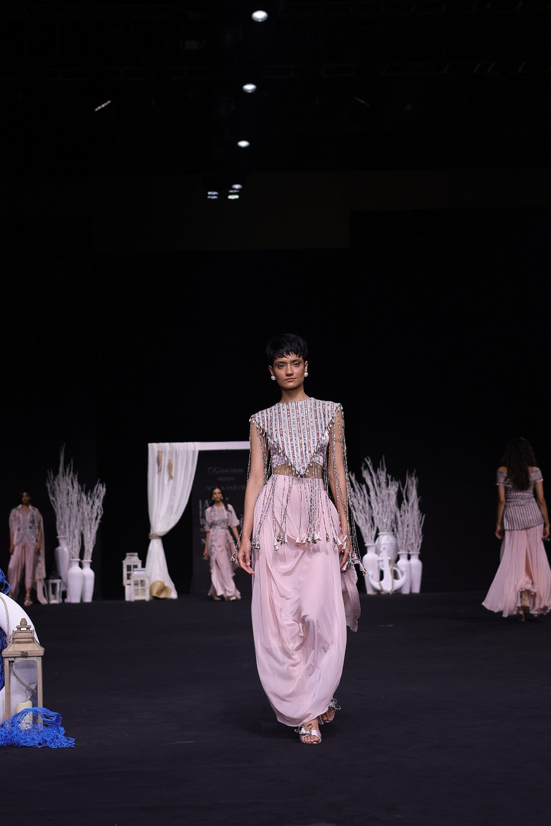 Peachy Pink ajrakh stripwork jacket paired up with Peachy pink bralette and drape dhoti skirt