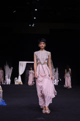 Peachy Pink ajrakh stripwork jacket paired up with Peachy pink bralette and drape dhoti skirt