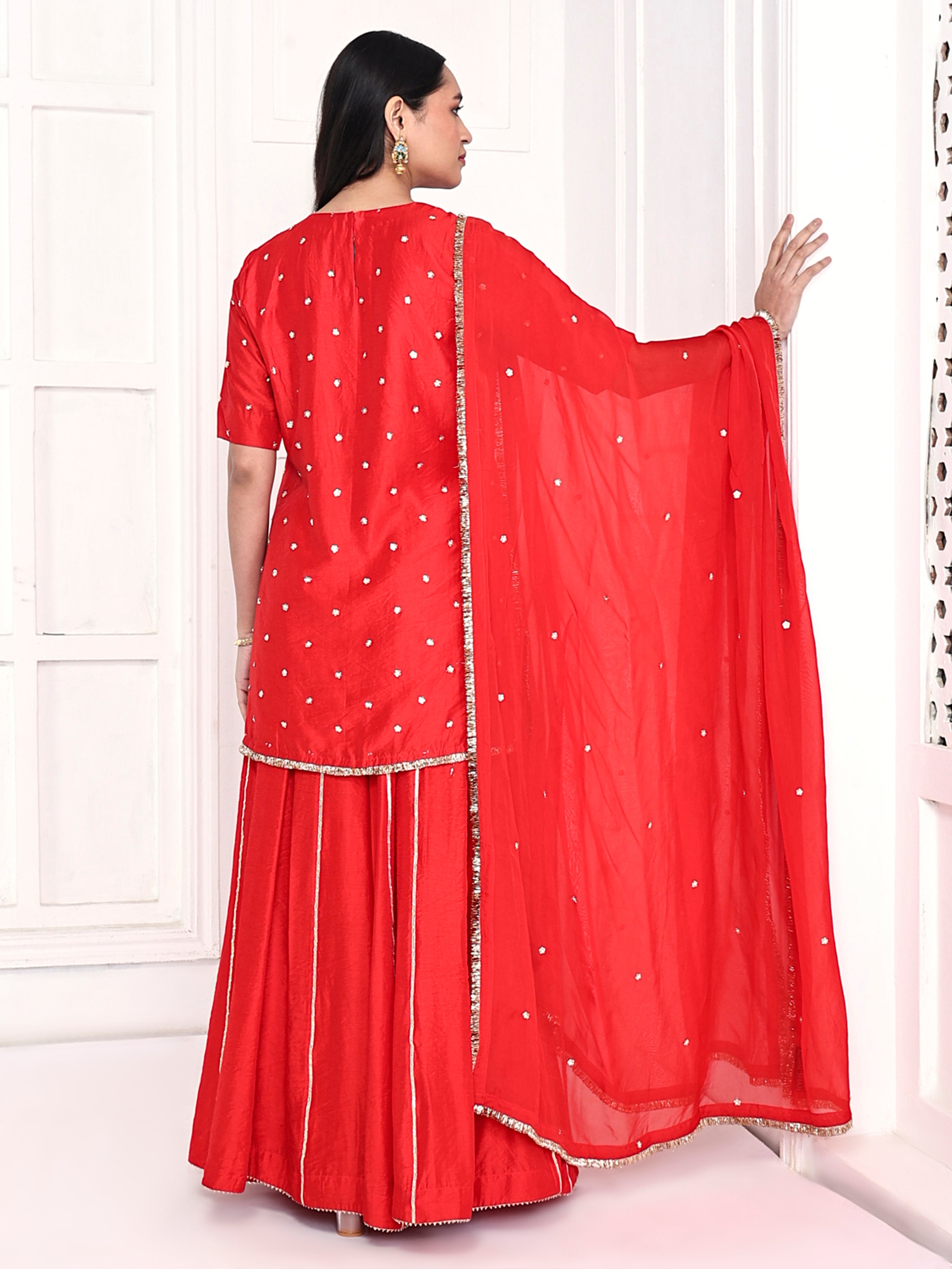 Short kurta is paired with kali palazzo and a dupatta