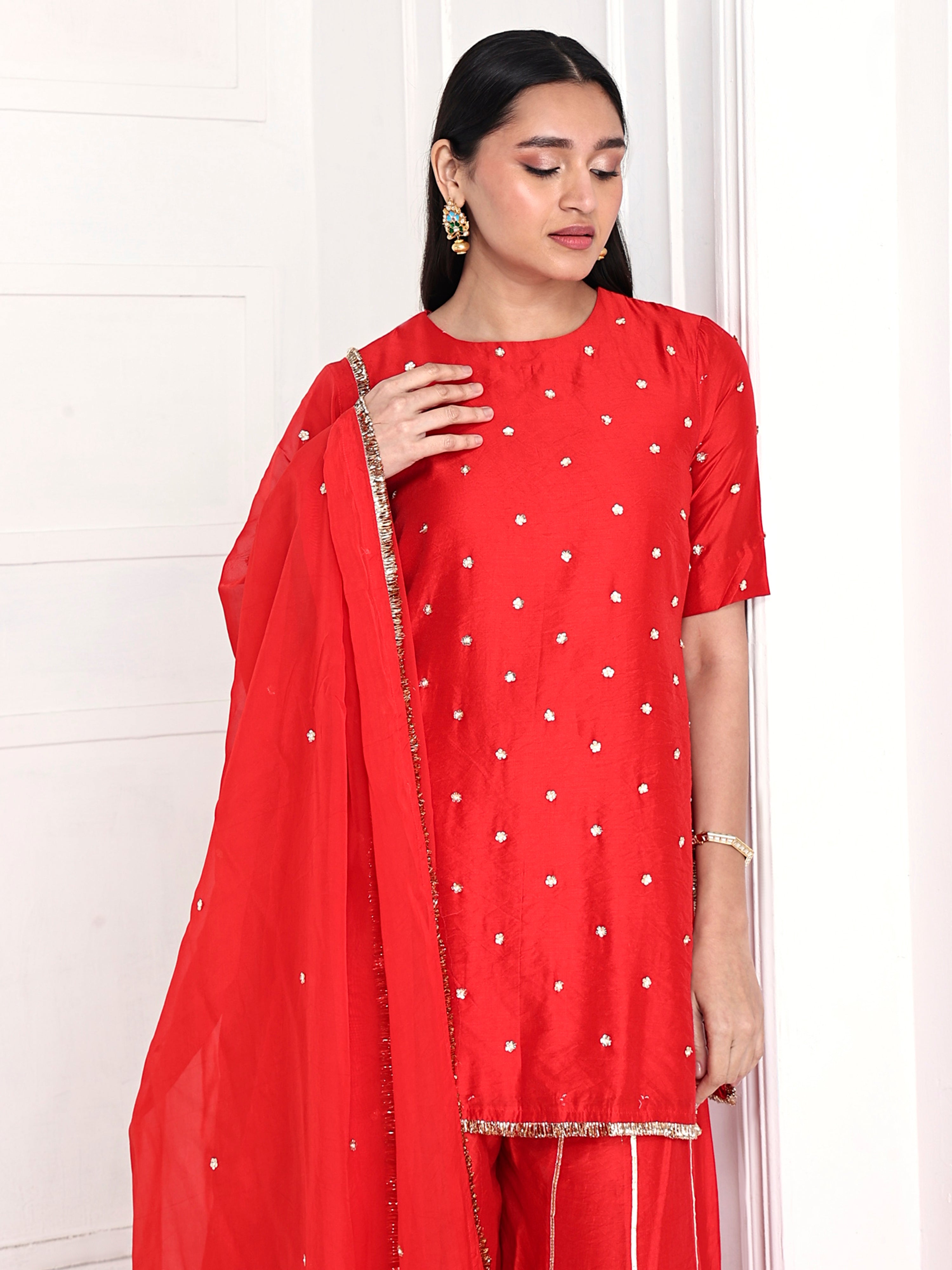 Short kurta is paired with kali palazzo and a dupatta