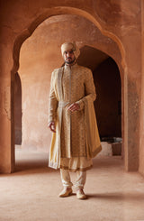 GOLD RAW SILK EMBROIDERED SHERWANI WITH A KALIDAR CHOGA AND CHURIDAR PYJAMA IN BEIGE MONGA TUSSAR