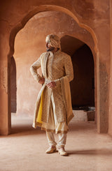 GOLD RAW SILK EMBROIDERED SHERWANI WITH A KALIDAR CHOGA AND CHURIDAR PYJAMA IN BEIGE MONGA TUSSAR