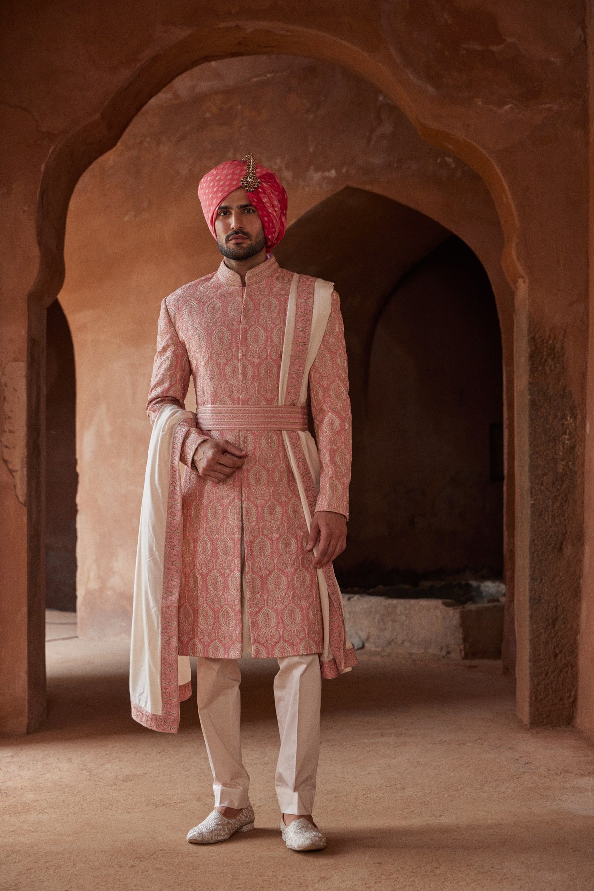 CORAL MATKA SILK SHERWANI ALL OVER EMBROIDERED WITH RESHAM AND BEADWORK WITH A BLUSH MONGA TUSSAR KURTA AND COTTON LYCRA TROUSERS