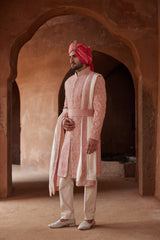 CORAL MATKA SILK SHERWANI ALL OVER EMBROIDERED WITH RESHAM AND BEADWORK WITH A BLUSH MONGA TUSSAR KURTA AND COTTON LYCRA TROUSERS