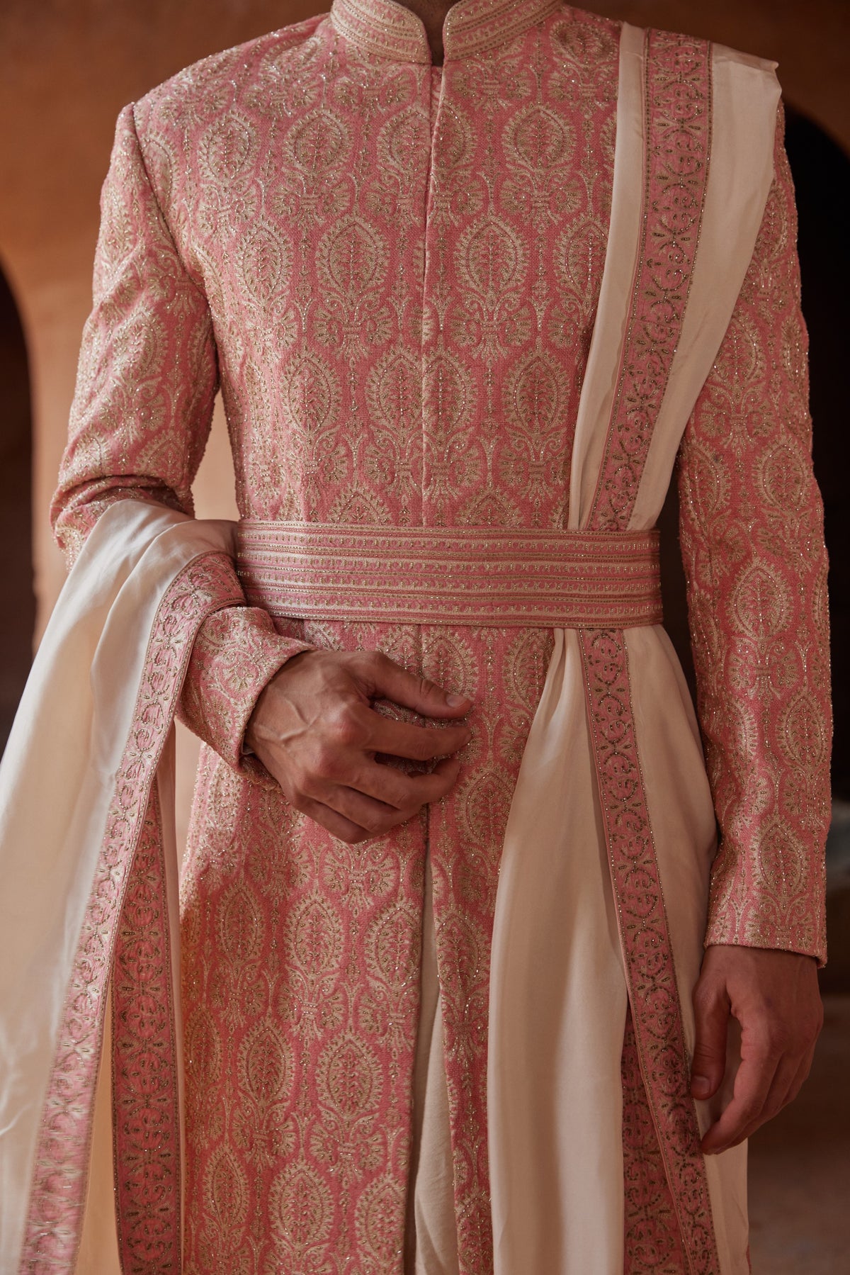 CORAL MATKA SILK SHERWANI ALL OVER EMBROIDERED WITH RESHAM AND BEADWORK WITH A BLUSH MONGA TUSSAR KURTA AND COTTON LYCRA TROUSERS