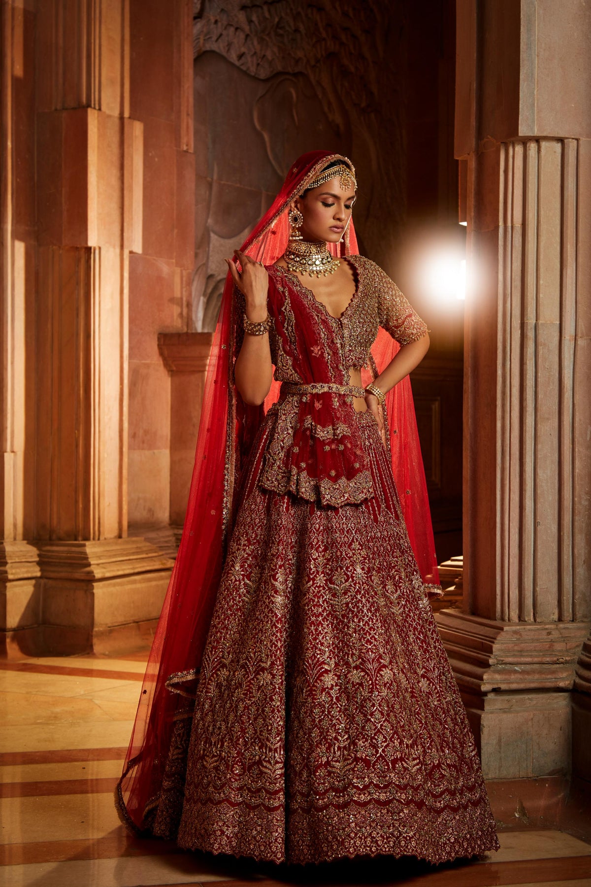 Jannat Khan In Blood Red Raw Silk Lehenga Choli and Belt with Tulle Dupatta with an Optional Lighter Second Dupatta