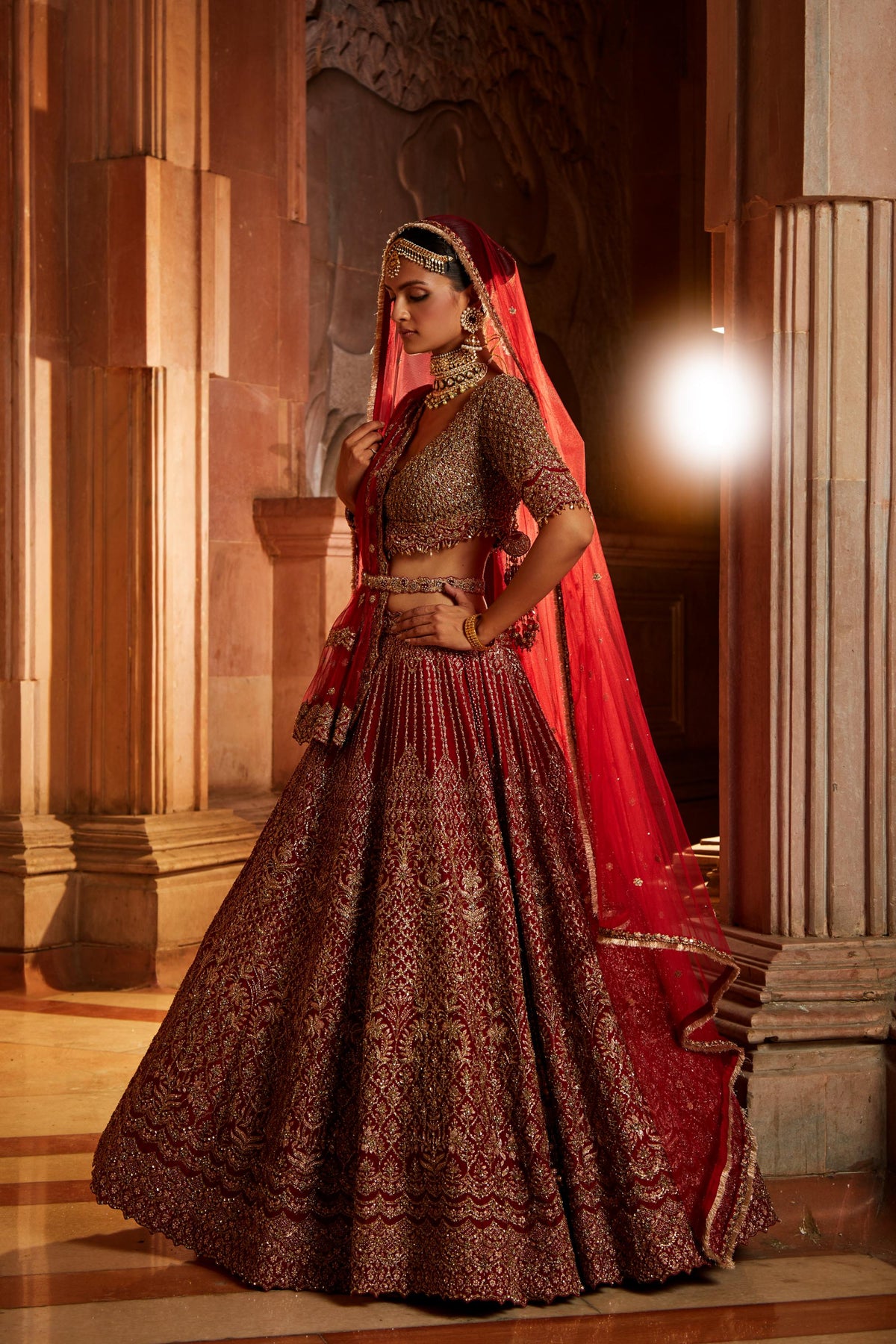 Jannat Khan In Blood Red Raw Silk Lehenga Choli and Belt with Tulle Dupatta with an Optional Lighter Second Dupatta