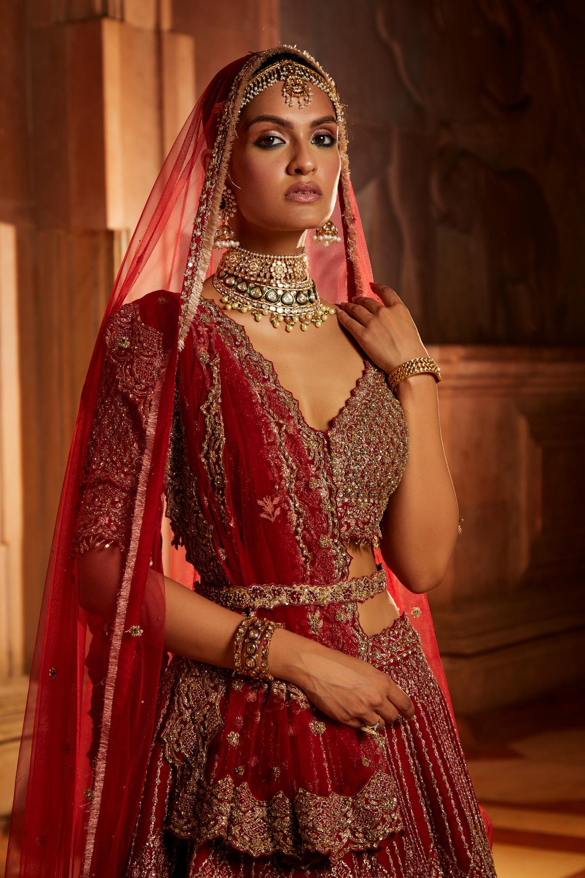Jannat Khan In Blood Red Raw Silk Lehenga Choli and Belt with Tulle Dupatta with an Optional Lighter Second Dupatta