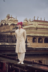 LIGHT BEIGE RAW SILK SHERWANI WITH KURTA AND CHURIDAR WITH OPTIONAL BELT, STOLE AND JUTIS