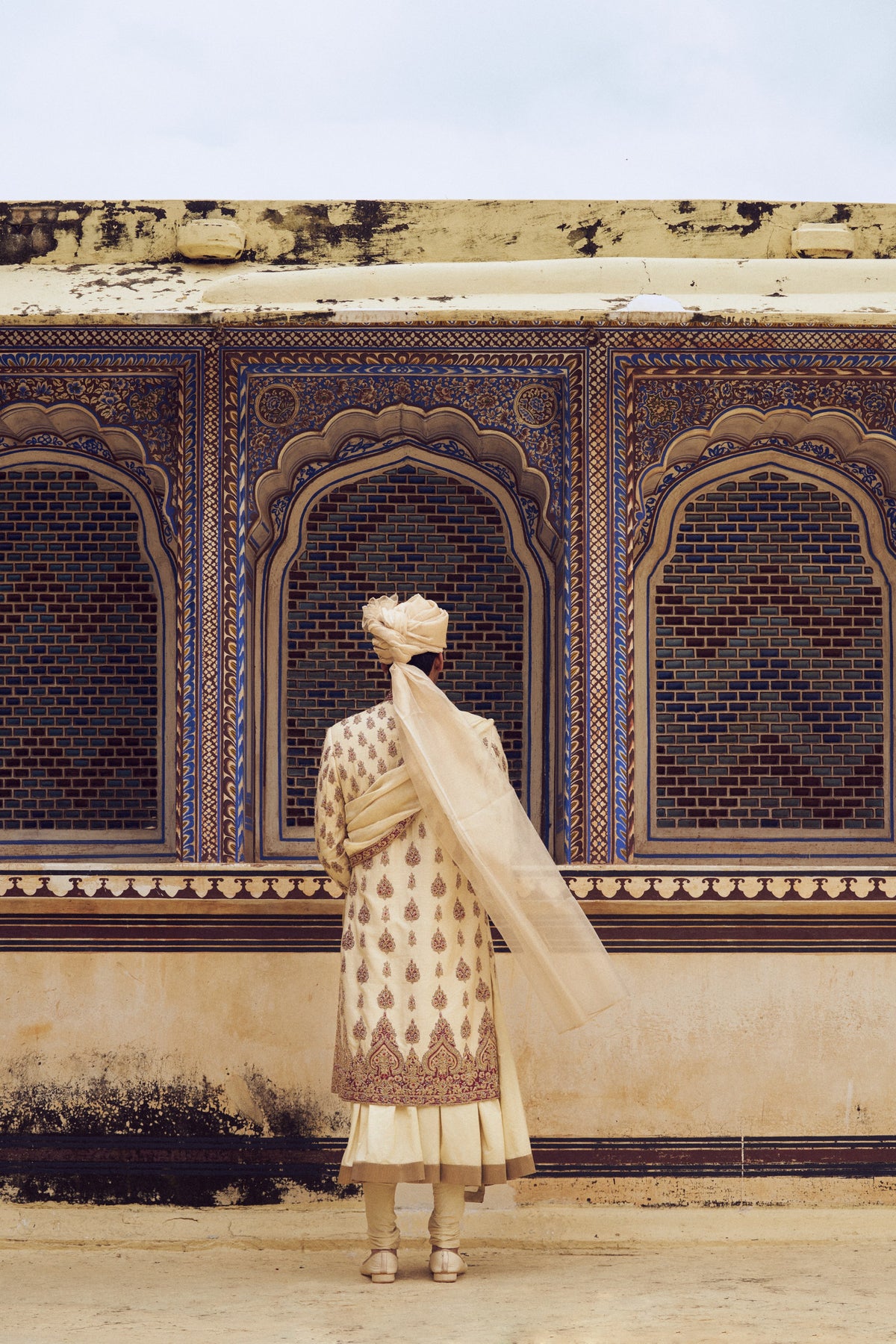 BEIGE RAW SILK SHERWANI WITH COTTON SILK CHOGA AND CHURIDAR WITH OPTIONAL STOLE AND JUTIS