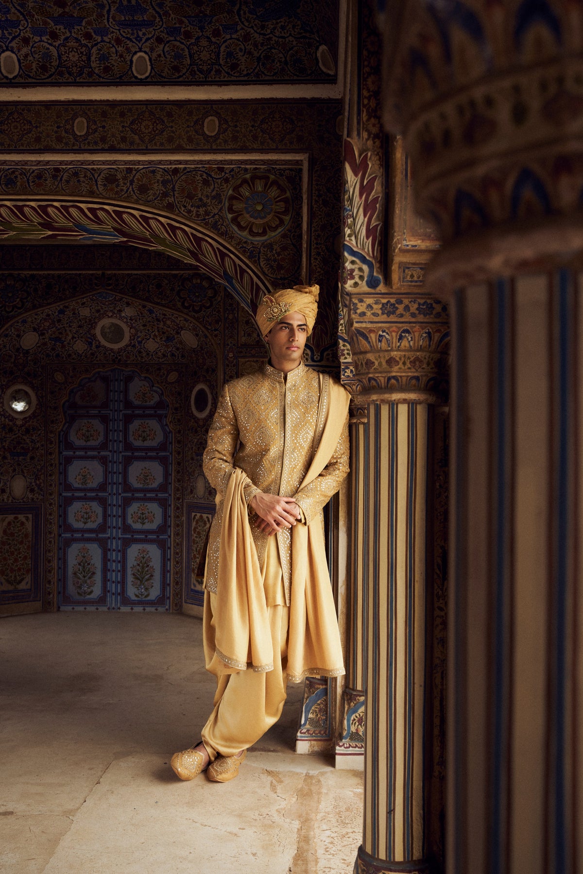 GOLD RAW SILK SHORT SHERWANI WITH SATIN KURTA AND DHOTI WITH OPTIONAL WORKED STOLE AND JUTIS