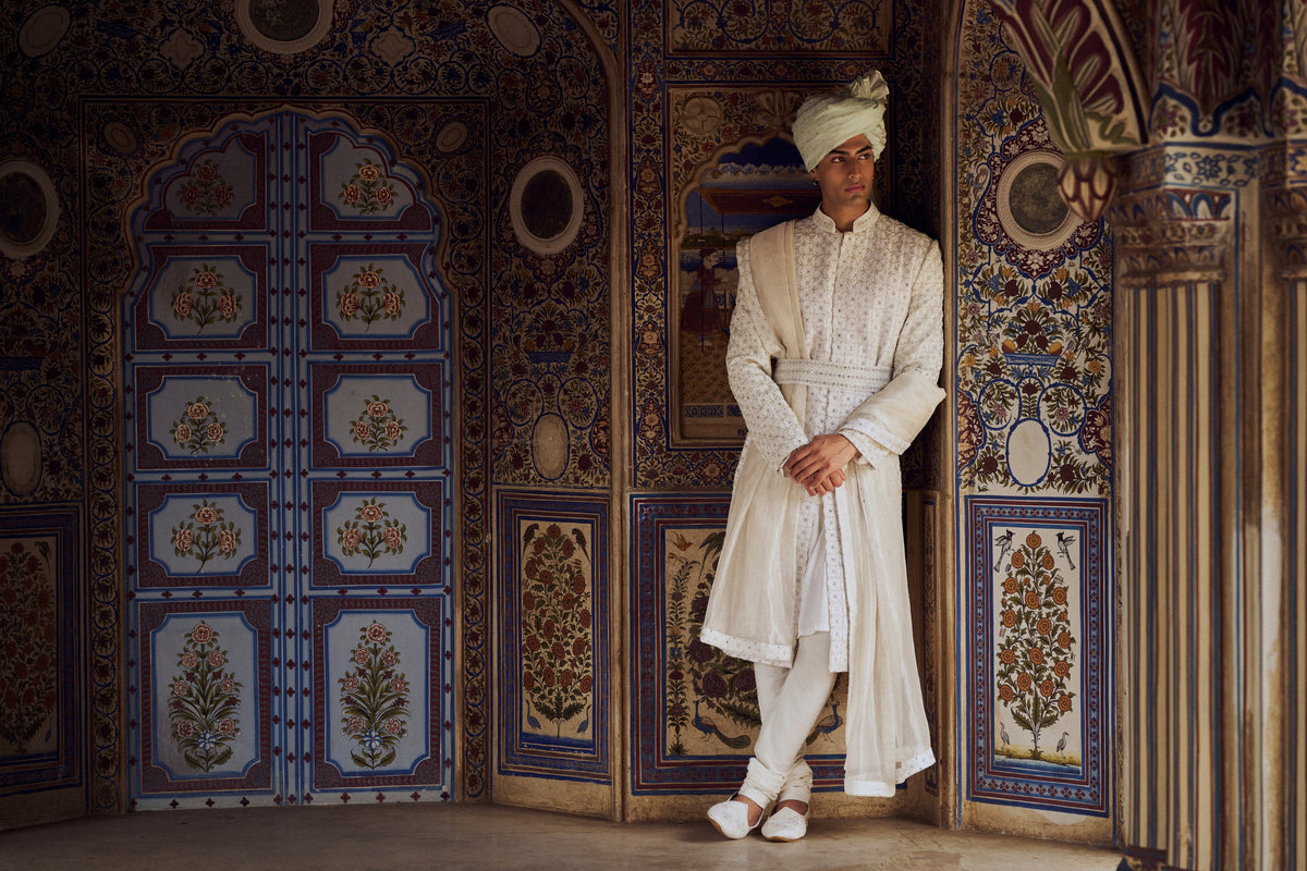 IVORY RAW SILK SHERWANI WITH KURTA CHURIDAR AND OPTIONAL STOLE, BELT AND EMBROIDERED JUTIS
