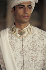 IVORY AND BEIGE RAW SILK SHERWANI SET WITH KURTA AND CHURIDAR WITH OPTIONAL BELT, STOLE AND JUTIS