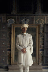 IVORY RAW SILK SHERWANI WITH KURTA AND CHURIDAR WITH OPTIONAL WORKED STOLE, BELT AND EMBROIDERED JUTIS