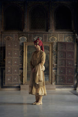 GOLD MATKA SILK ANGRAKHA STYLE SHERWANI WITH CHANDERI BOOTI CHOGA AND CHURIDAR WITH OPTIONAL BELT, STOLE AND WORKED JUTIS